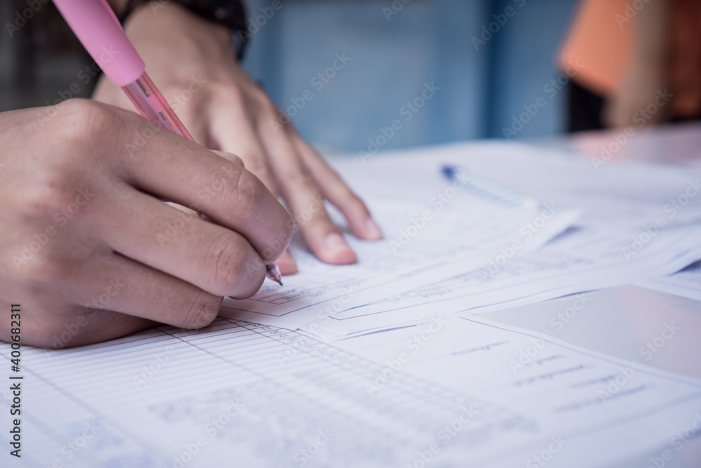Hands Student testing in exam on exercise taking at high school or university in test room. Writing document exams at campus classroom, back to school and evaluation measurement in education Hands Student testing in exam on exercise taking at high school or university in test room. Writing document exams at campus classroom, back to school and evaluation measurement in education
