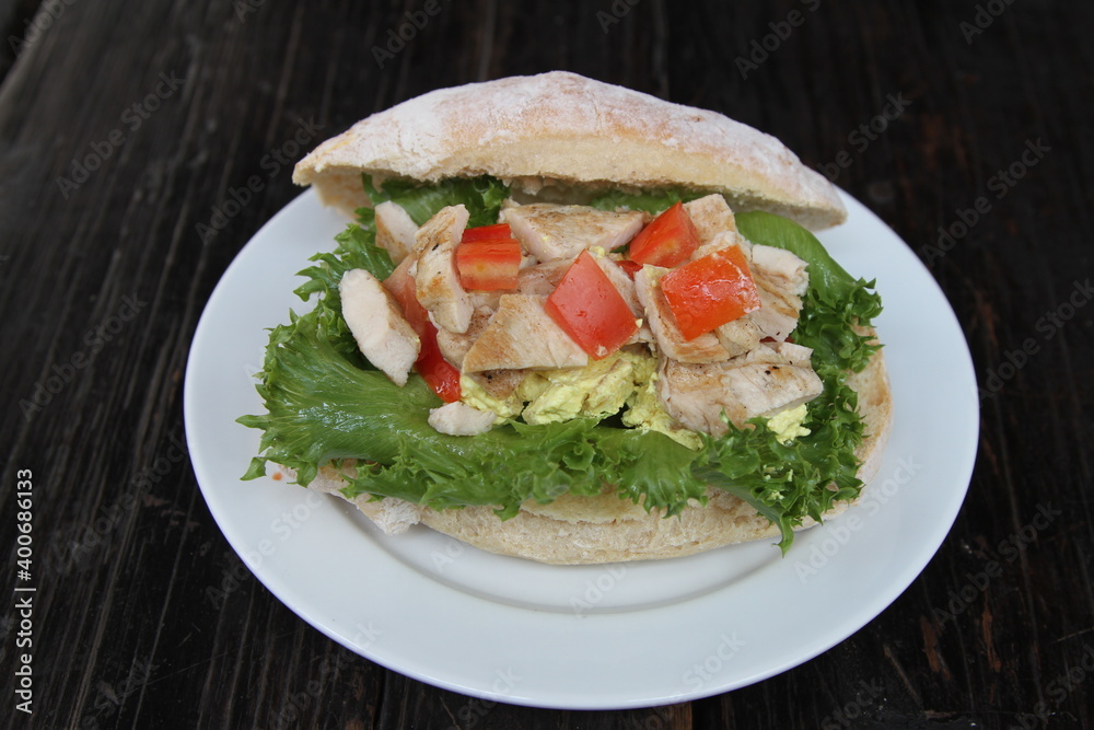 Italian ciabatta roll with grilled chicken, tomatoes, lettuce and mustard cream