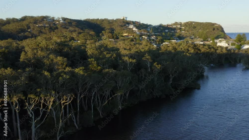 Low flying twisting drone footage of Avoca Lake, near Avoca beach from