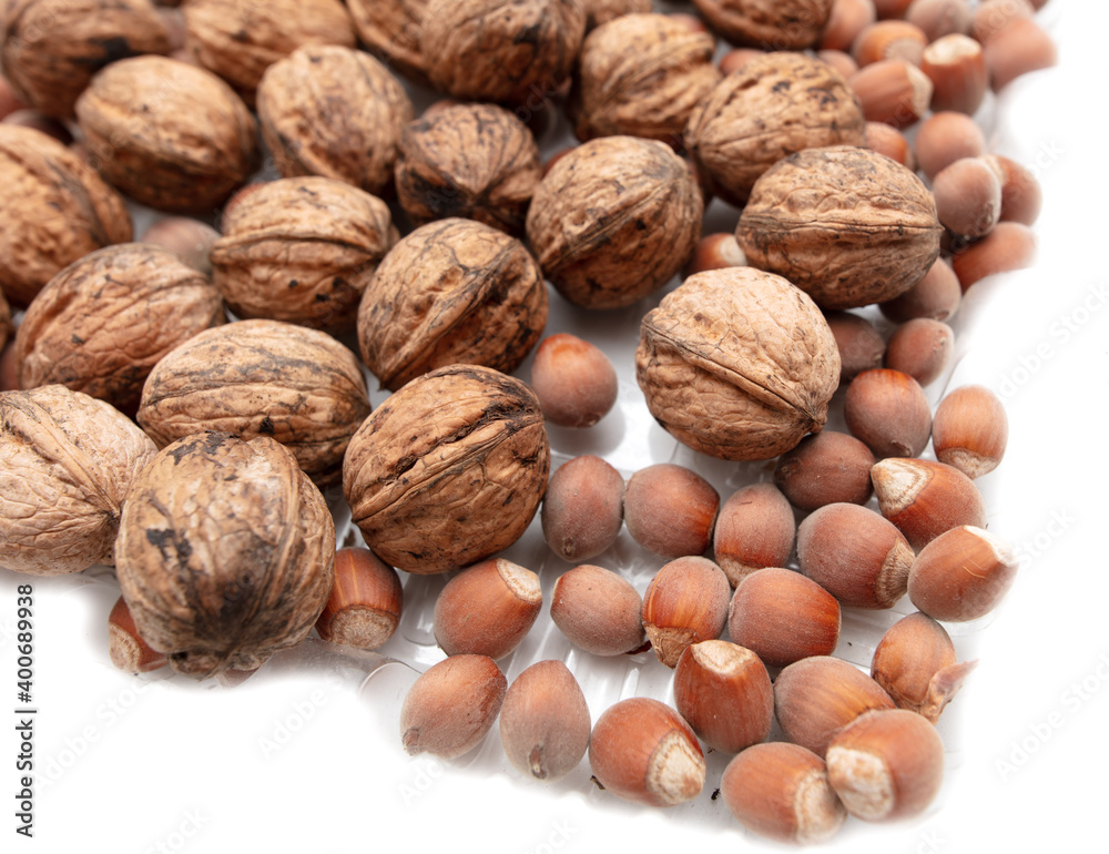 Walnuts and hazelnuts on a white Walnuts and hazelnuts on a white