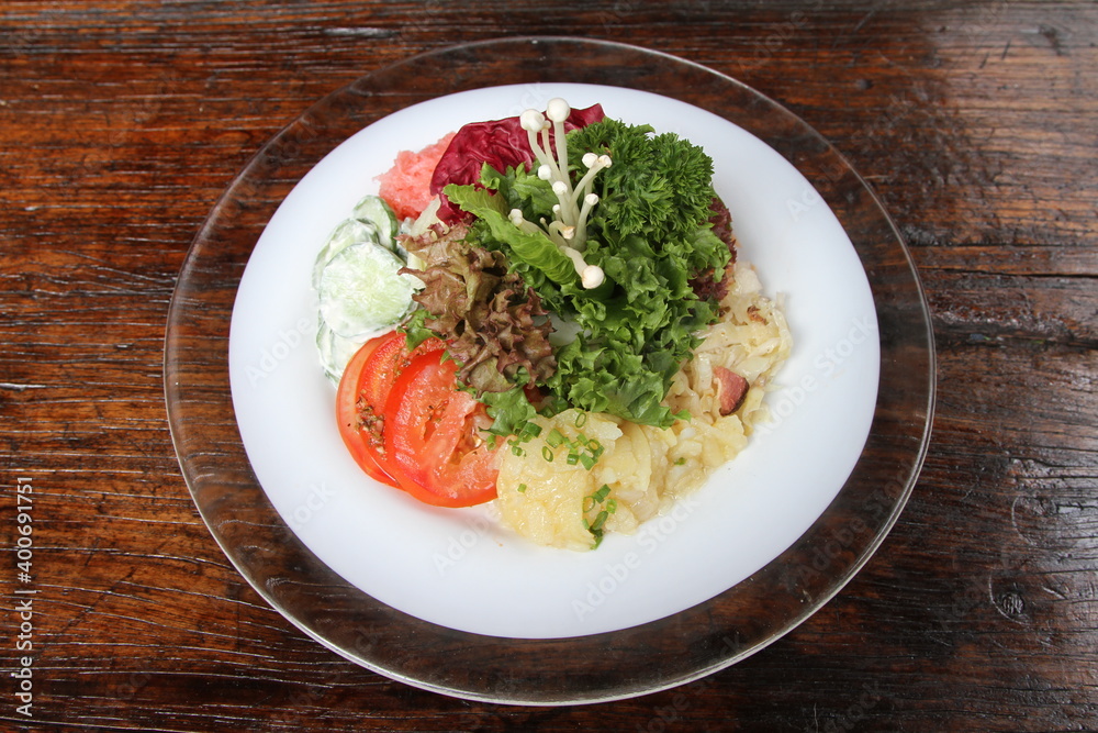 Mixed salad platter with greens ,tomato, cucumber and potato salad Mixed salad platter with greens ,tomato, cucumber and potato salad