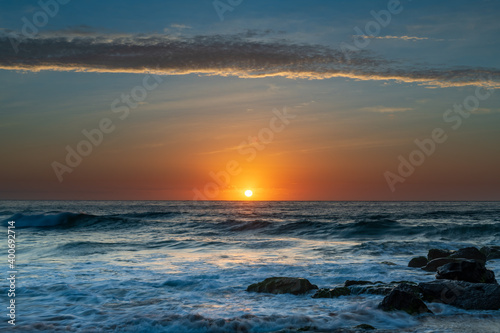 Beautiful sunrise with high cloud at the seaside © Merrillie