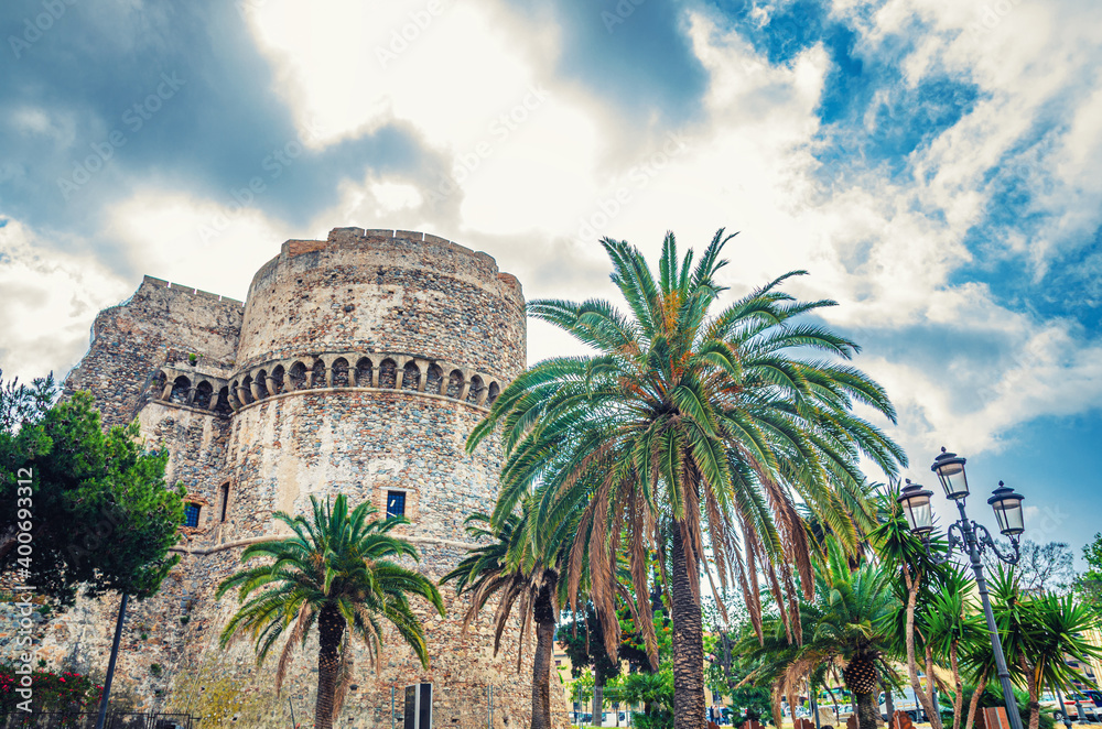 Aragonese Castle Castello Aragonese stone medieval buildings and palm trees in Piazza castello square in Reggio Calabria historical city centre, Southern Italy