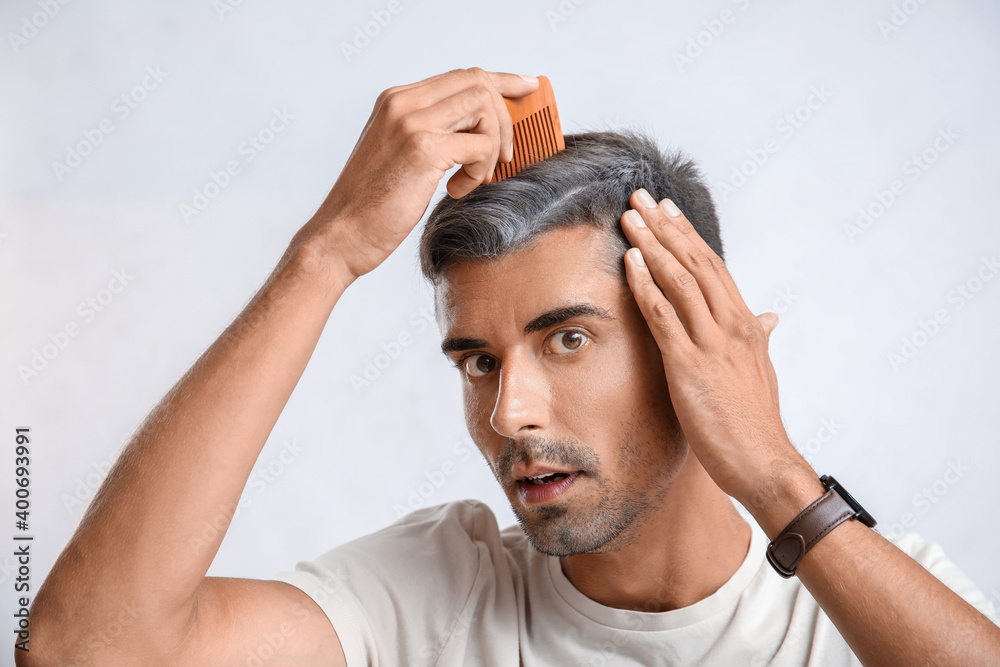Stressed man with graying hair on light background Stressed man with graying hair on light background