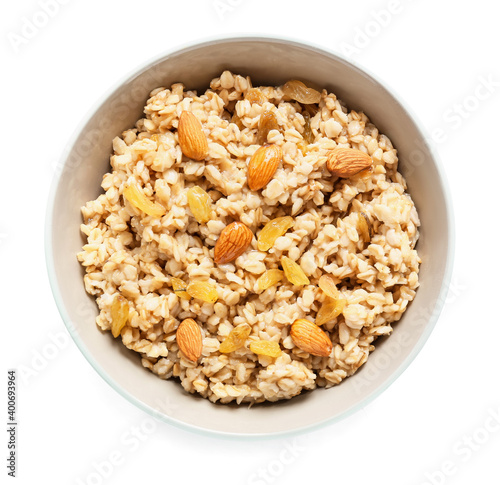 Bowl with tasty sweet oatmeal on white background