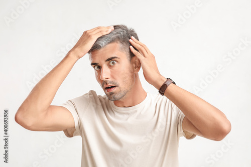 Stressed man with graying h...