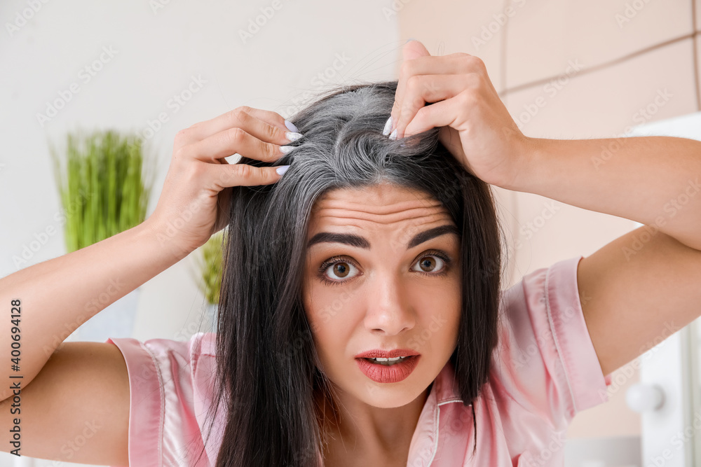 Naklejka premium Stressed woman with graying hair at home