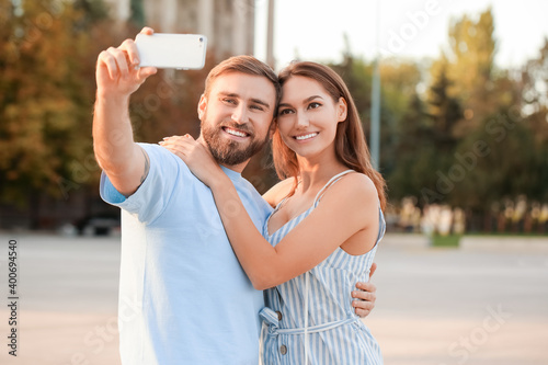 Young couple taking selfie ...