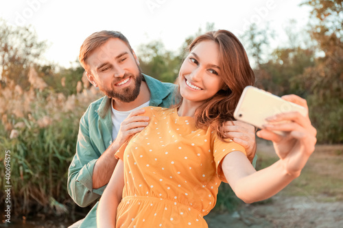 Young couple taking selfie ...
