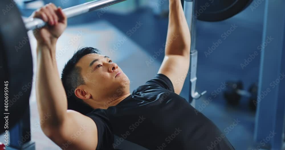 Japanese middle aged strong man doing heavy weighlifting barbell exercise in the gym. Determination. People in sports. Active lifestyle. Japanese middle aged strong man doing heavy weighlifting barbell exercise in the gym. Determination. People in sports. Active lifestyle.