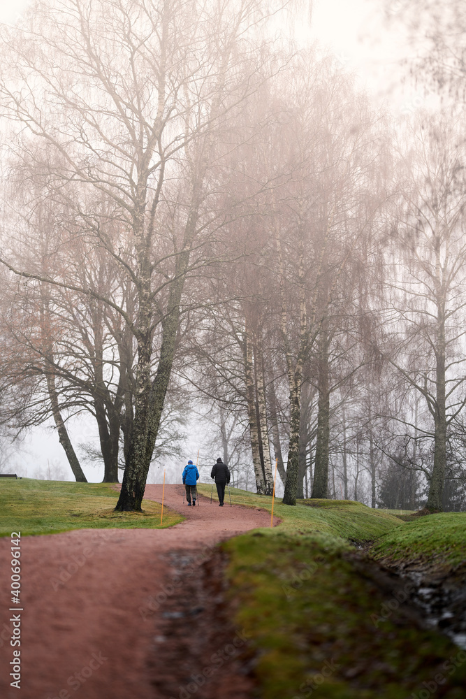 Trekking in a rainy and foggy day. Shot in Norway. Fog and rain and not stopping people to go outside for their daily walks. People in Norway are very found of hiking and trekking regardless.