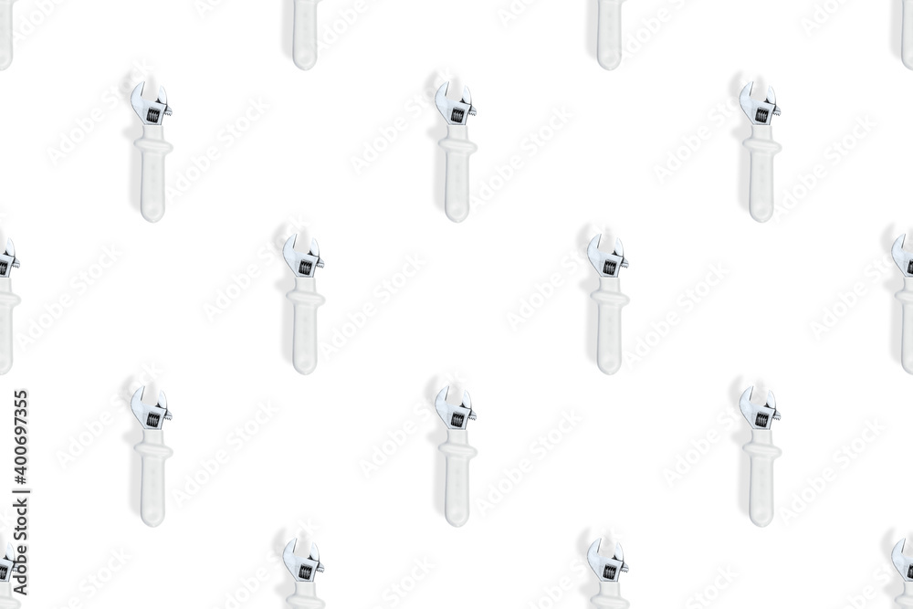 Wrench on a white background. Seamless background from adjustable metal wrench. Seamless patterns. Wrench on a white background. Seamless background from adjustable metal wrench. Seamless patterns.