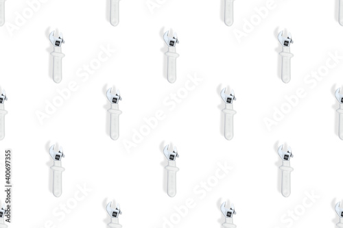 Wrench on a white background. Seamless background from adjustable metal wrench. Seamless patterns.