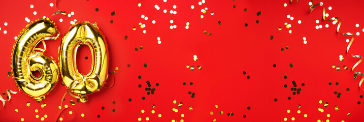 Gold foil balloon number, digit sixty. Birthday greeting card with inscription 60. Anniversary celebration event. Banner. Golden numeral, red background. Numerical digit, light bokeh, glitter.