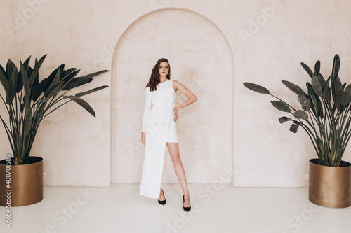 Beautiful girl in a dress on a fashion photoshoot in a photostudio