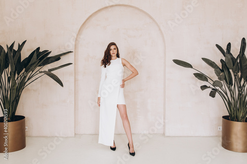 Beautiful girl in a dress on a fashion photoshoot in a photostudio