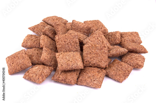 chocolate pillows for breakfast isolated on white background. Brown choco cereal pads with cream