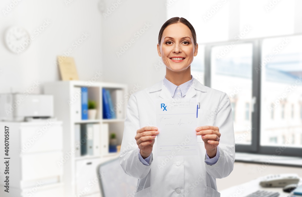 medicine, profession and healthcare concept - happy smiling female doctor in white coat holding prescription blank over hospital background
