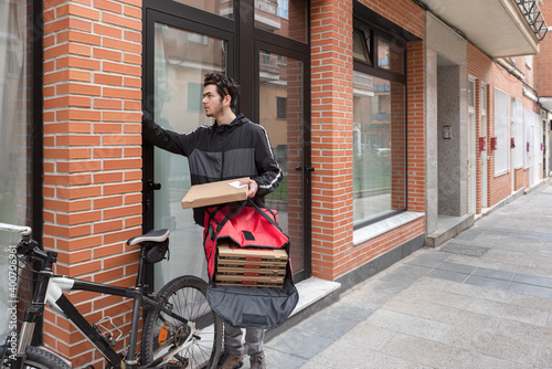 Courier to deliver food at building site with bicycle