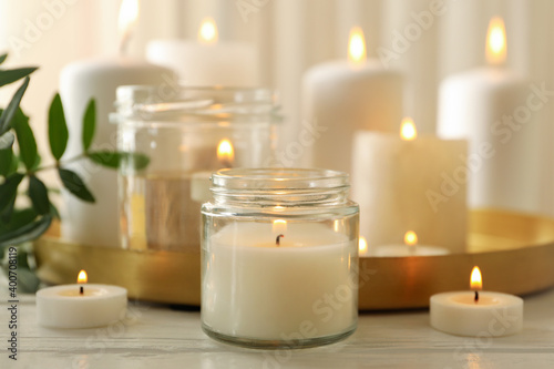 Burning scented candles for relax on white wooden table