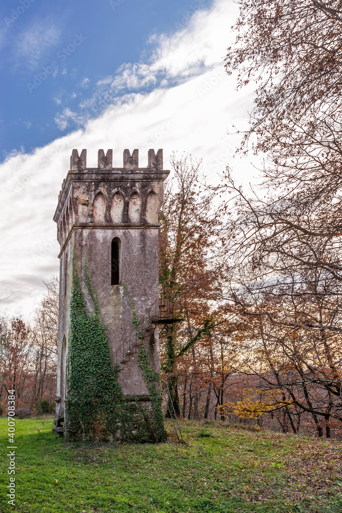 An ancient watchtower in the vicinity of the Tuscan town of Bientina, Italy, with autumn colors on the trees near it