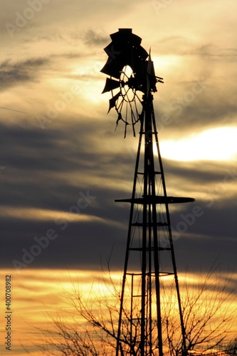 silhouette of a windmill at sunset with a colorful sky north of Hutchinson Kansas USA. photo