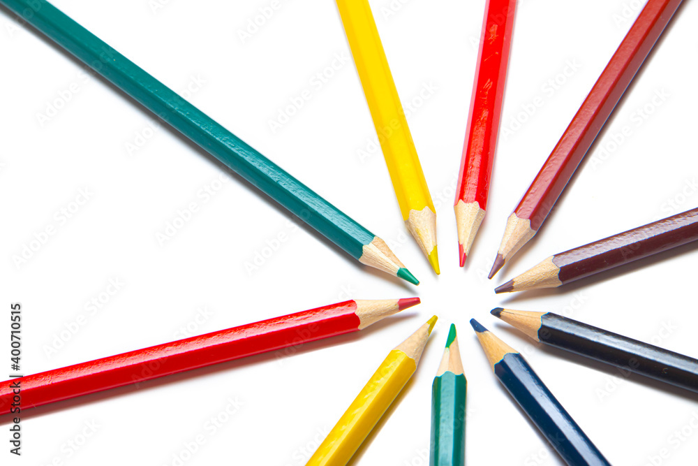 Colored pencils in a circle on a white background . Office supplies. Children's drawing. Hello school .