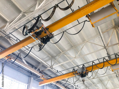 Overhead cranes inside industrial building. Bridge cranes inside hangar