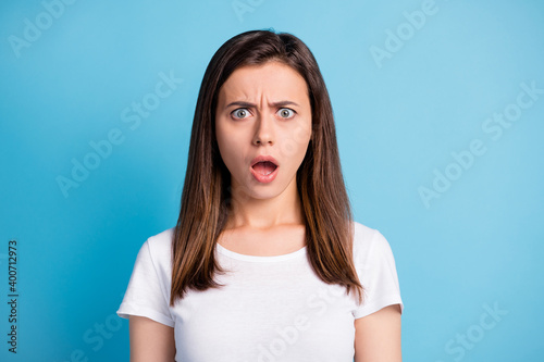 Photo of frightened shocked young lady wear white clothes big eyes open mouth isolated blue color background © deagreez