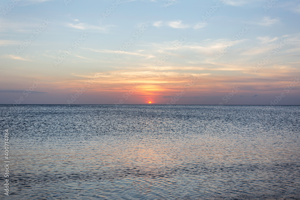 Fototapeta premium Calm sea with sunset sky. Meditation ocean and sky background. Tranquil seascape. Horizon over the water