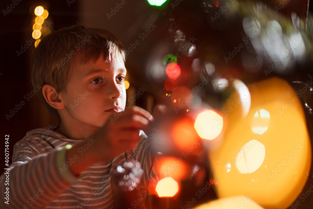Portrait of 8 years old boy decorating Christmas tree Portrait of 8 years old boy decorating Christmas tree