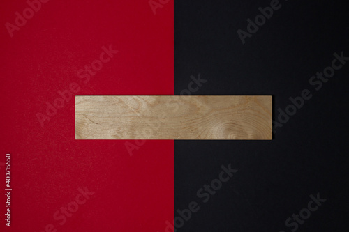 Empty wooden board for an inscription. Wooden plaque on a black-red background.