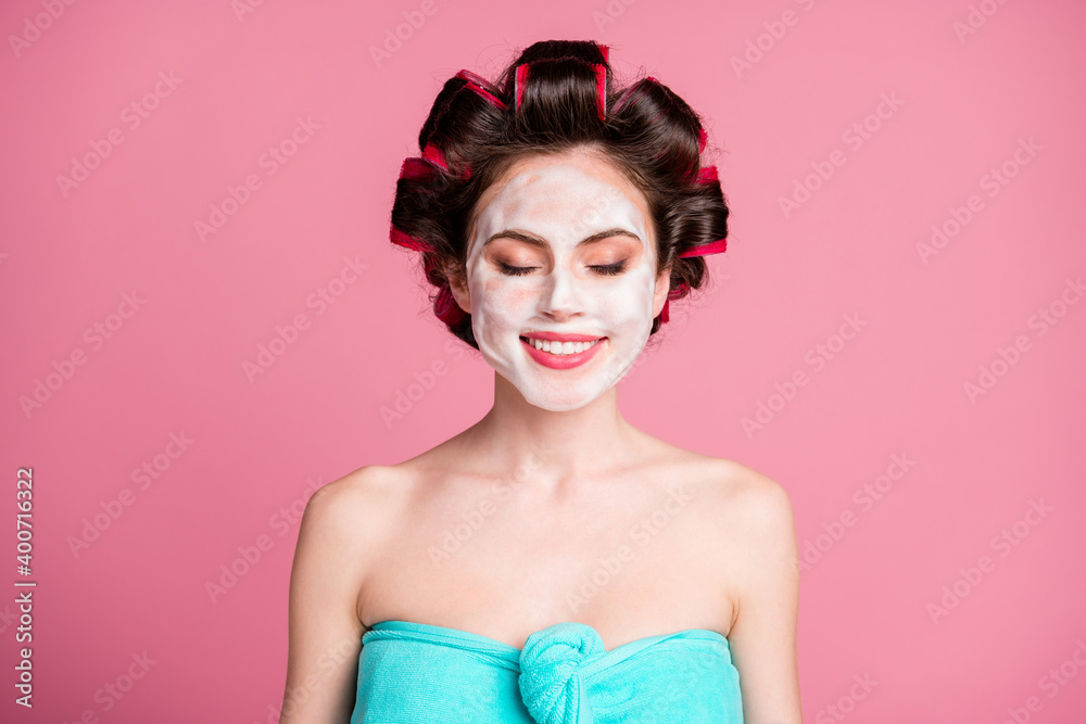 Close-up portrait of pretty dreamy cheery housewife wearing mousse on face lift procedure isolated on pink color background