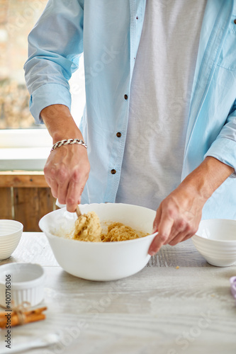 Man, male forming the dough in Bowl a and kneading at home