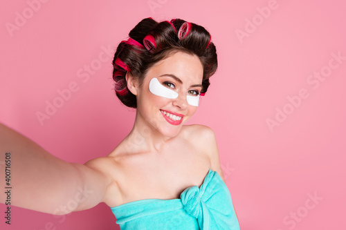 Photo of positive girl spa salon skin care procedure make selfie eye patches wear towel isolated pastel color background