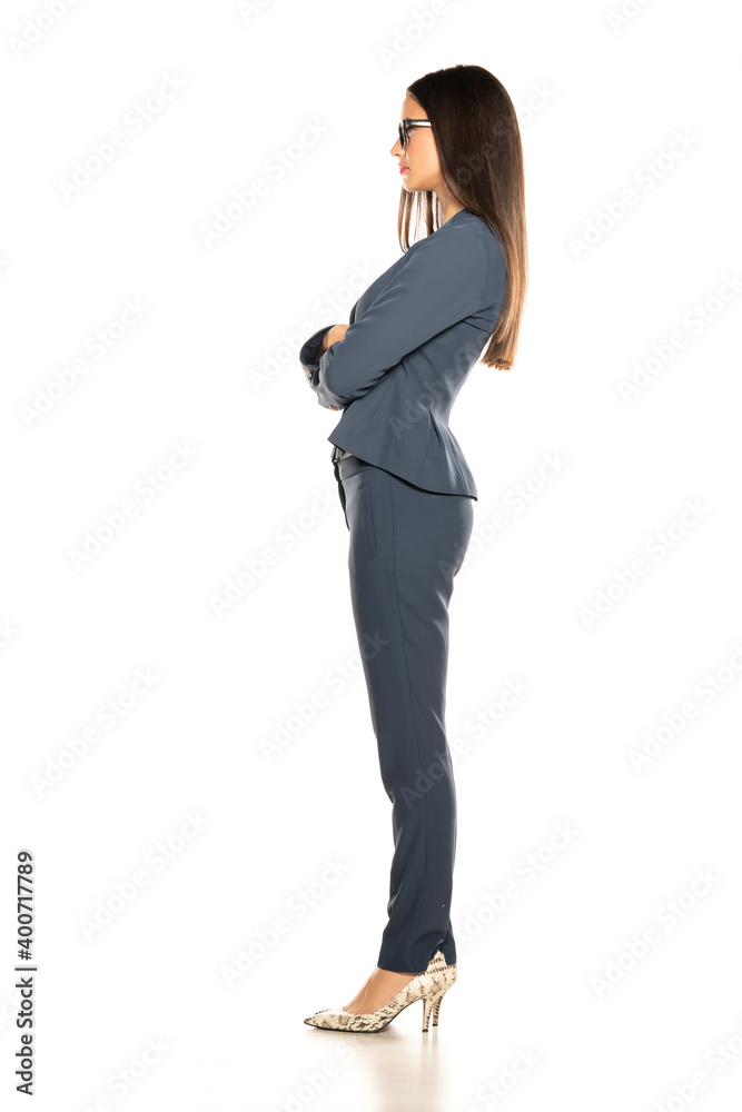 Side view of young beautiful business woman in a pants and jacket Side view of young beautiful business woman in a pants and jacket