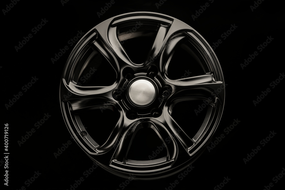 Obraz premium matte black alloy wheel, close-up front view. Powerful wheel for off-road vehicles