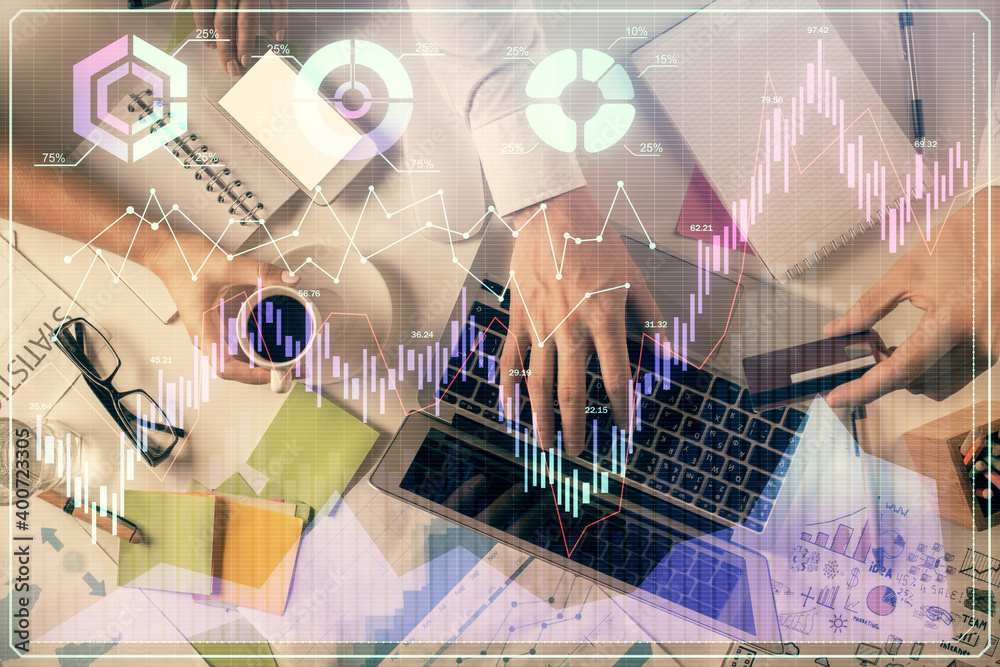 Double exposure of man and woman working together and forex graph hologram drawing. Financial analysis concept. Computer background. Top View. Double exposure of man and woman working together and forex graph hologram drawing. Financial analysis concept. Computer background. Top View.