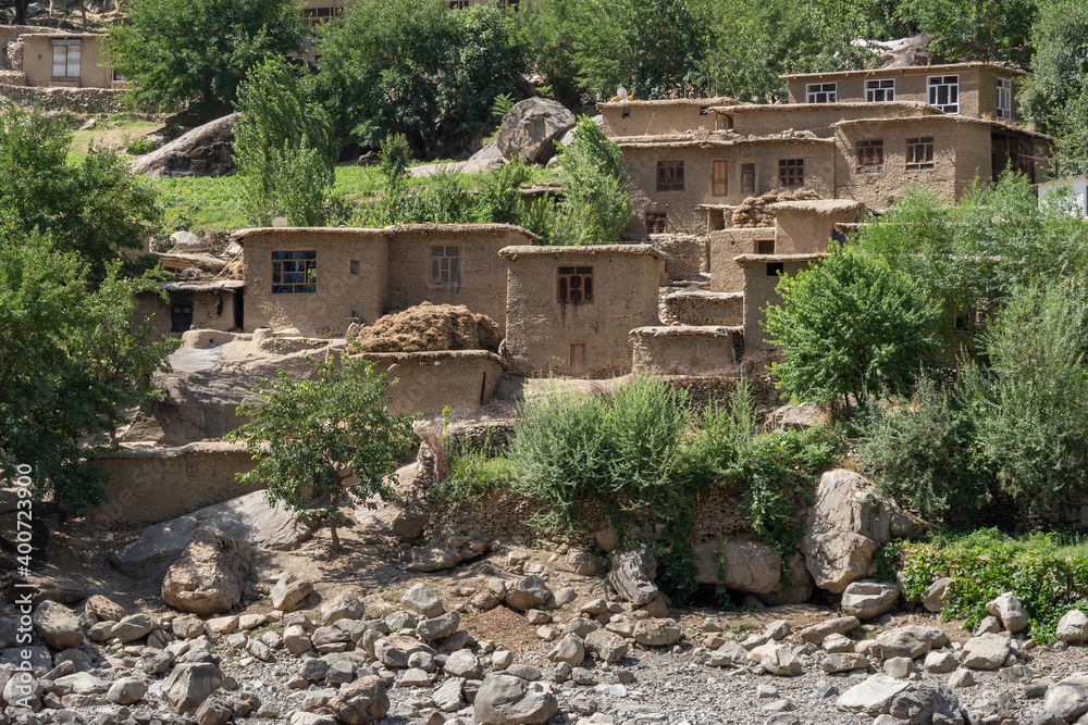 Fototapeta premium Remote traditional Afghan village in the Panj river valley, taken from Darvaz district in Gorno-Badakshan, the Pamir mountain region of Tajikistan
