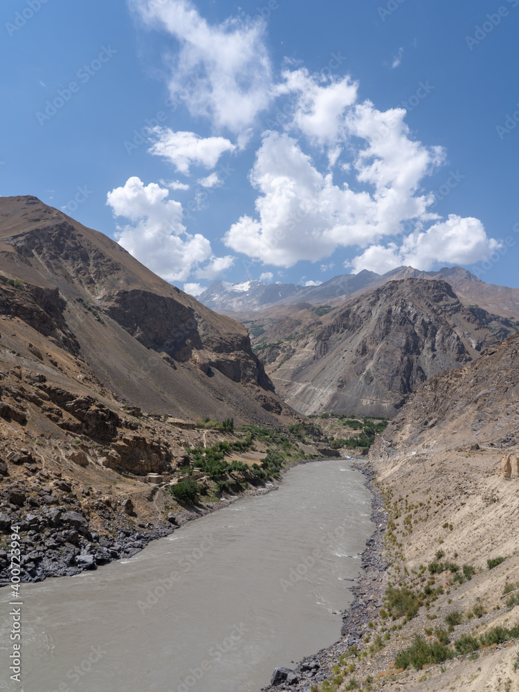 View of the Panj river valley between Tajikistan and Afghanistan from Darvaz district in Gorno-Badakshan, the Pamir mountain region of Tajikistan with beautiful clouds
