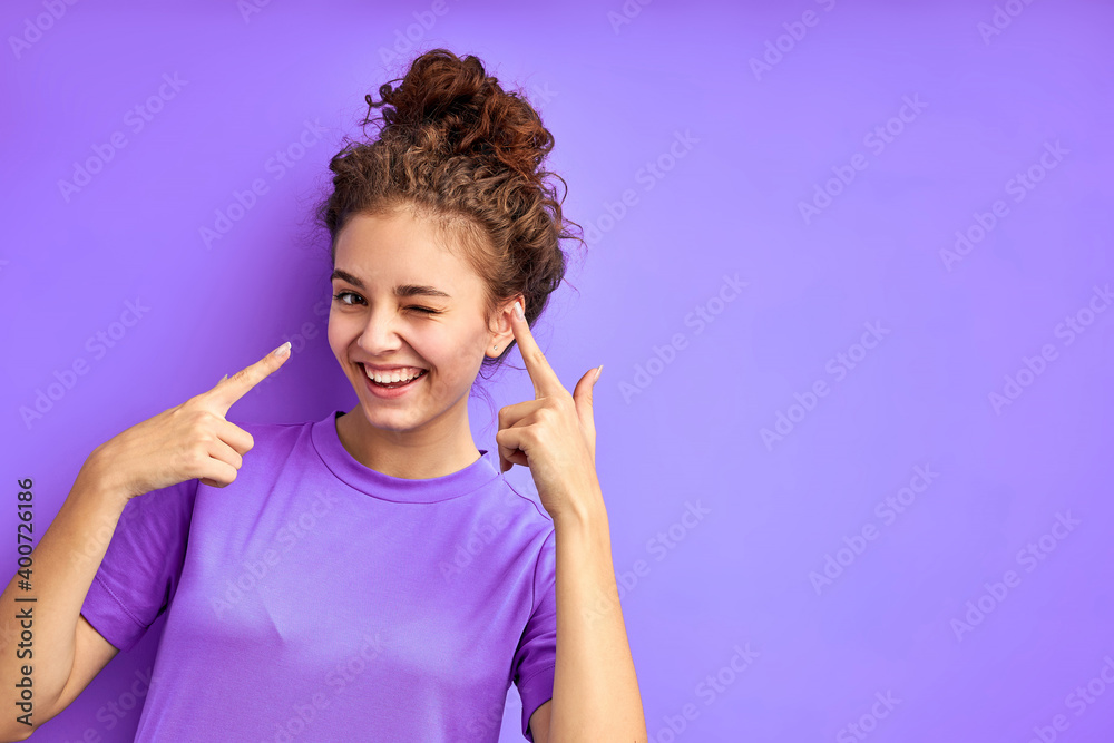 cute joydul cheerful girl have fun posing isolated in studio with purple background, attractive emotional female in shirt look at camera cute joydul cheerful girl have fun posing isolated in studio with purple background, attractive emotional female in shirt look at camera