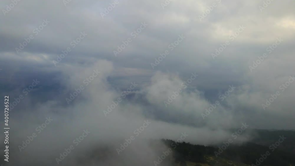 Flying Over The Layer Of Clouds And Looking On Landscape Through The Clouds. Flying Over The Layer Of Clouds And Looking On Landscape Through The Clouds.