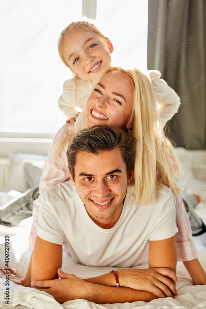 portrait of happy family on bed, they have rest, enjoy time together in the morning at home