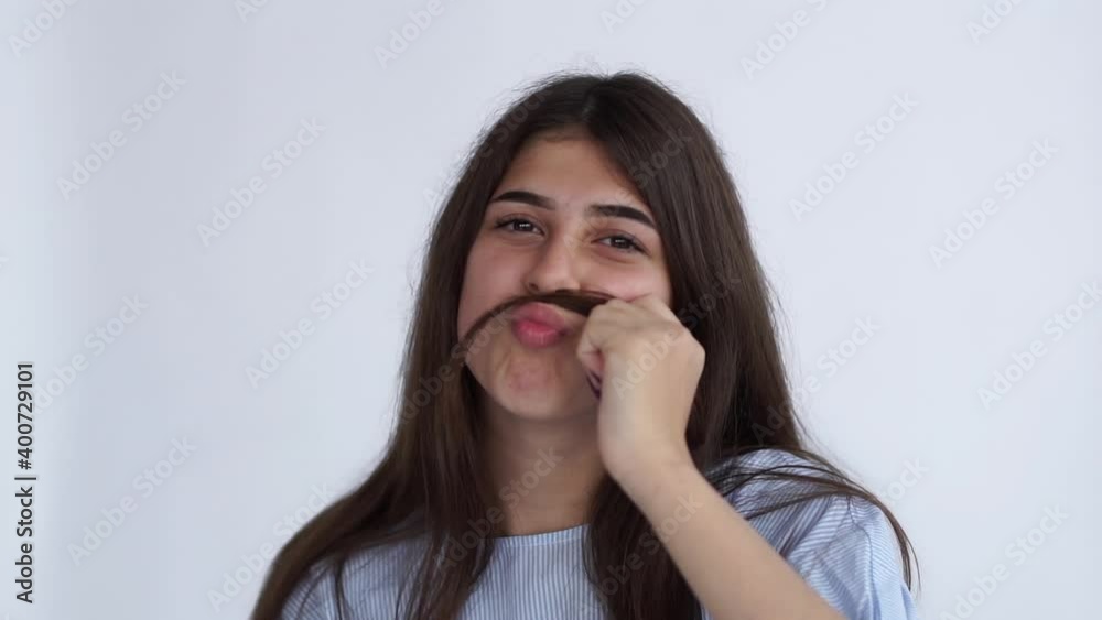 The young woman made a mustache out of her hair The young woman made a mustache out of her hair