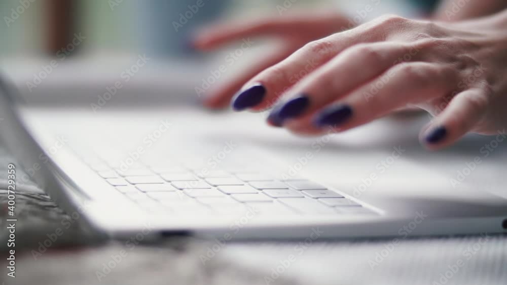 Woman is typing something on a laptop. Woman is typing something on a laptop.