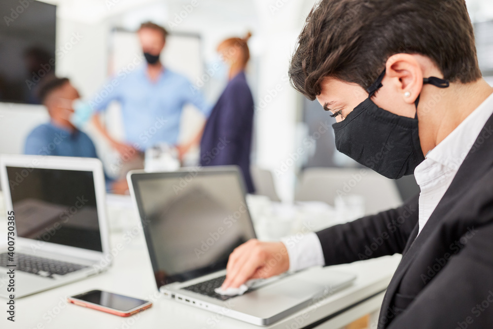 Businessman disinfecting the PC keyboard Businessman disinfecting the PC keyboard