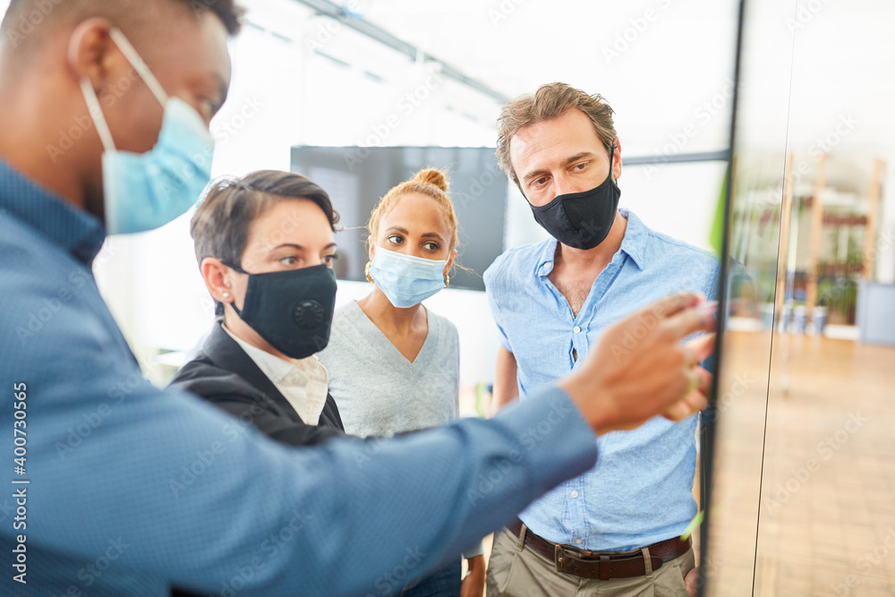 Business colleagues with everyday mask in the office Business colleagues with everyday mask in the office