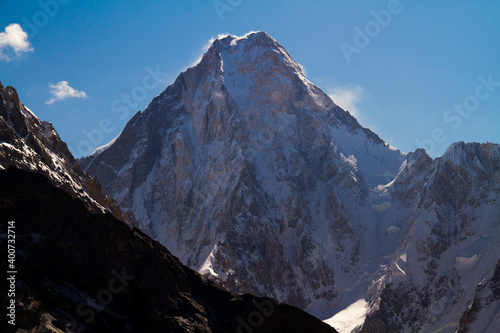g4 in morning light, mountain lanscape with white clouds and blue sky, Gasherbrum V is a mountain in the Gasherbrum massif, located in the Karakoram range of Gilgit–Baltistan, Pakistan photo