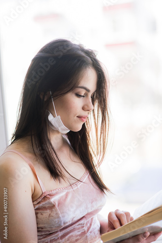 Free Download Beautiful female in quarantine wearing protective mask and working at home - GFXLoad