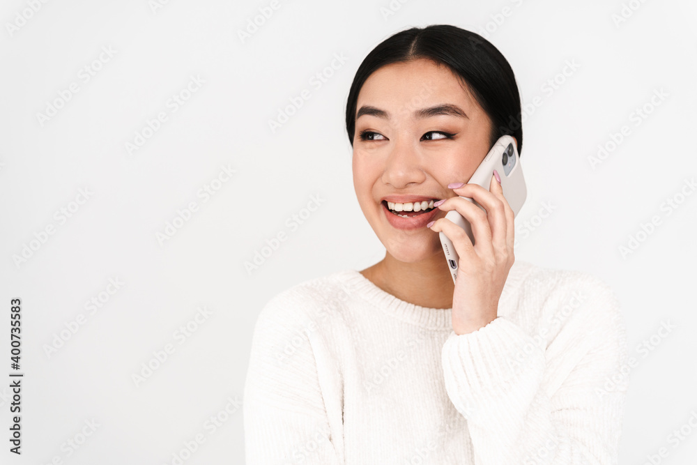 Asian laughing nice girl laughing while talking on mobile phone Asian laughing nice girl laughing while talking on mobile phone